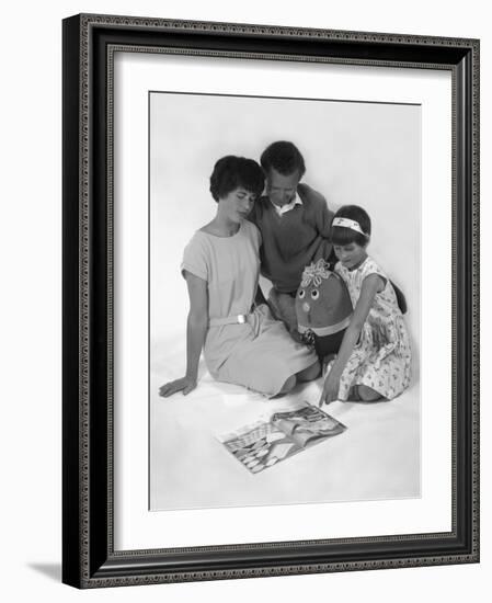 Family Group Looking at a Magazine, 1963-Michael Walters-Framed Photographic Print