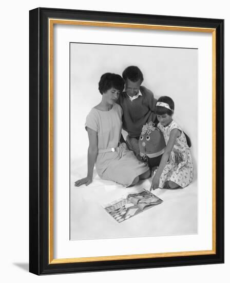 Family Group Looking at a Magazine, 1963-Michael Walters-Framed Photographic Print