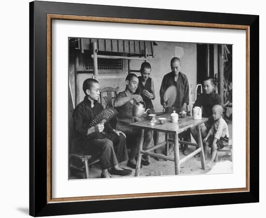 Family Having Tea in Courtyard-Carl Mydans-Framed Photographic Print