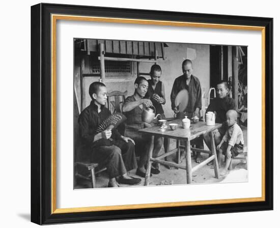 Family Having Tea in Courtyard-Carl Mydans-Framed Photographic Print