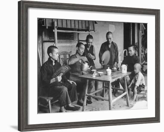 Family Having Tea in Courtyard-Carl Mydans-Framed Photographic Print