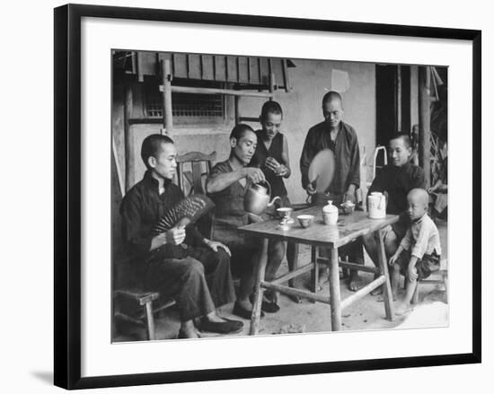 Family Having Tea in Courtyard-Carl Mydans-Framed Photographic Print