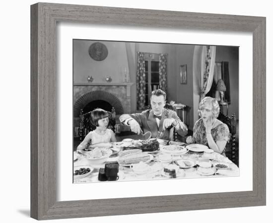 Family of Three Sitting Together Having Dinner-null-Framed Photo