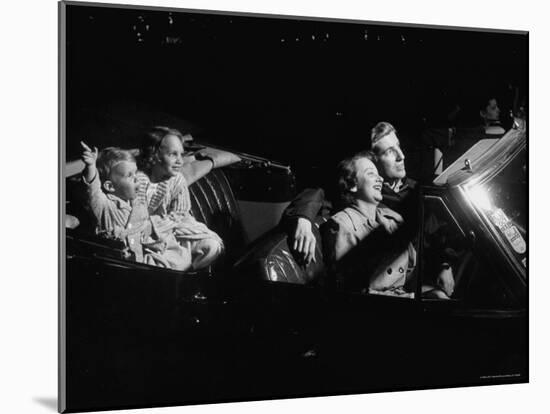 Family Sitting in Convertible Watching Movie at Drive In-Francis Miller-Mounted Photographic Print