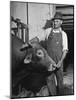 Farm Worker Petting One of the Cows Living on a Dairy Farm-Hansel Mieth-Mounted Photographic Print