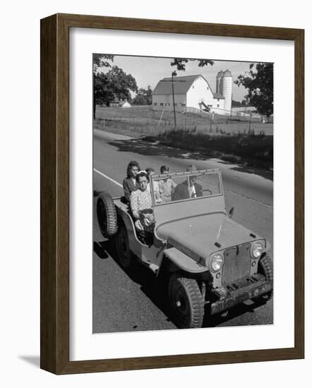 Farmer and Family Riding in a Jeep in Demonstration of Postwar Uses for Military Vehicles-null-Framed Photographic Print