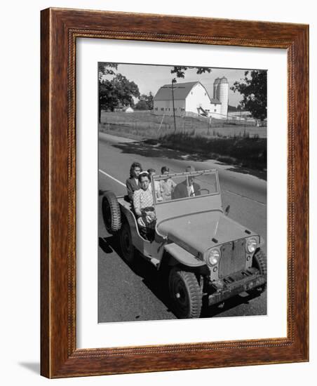 Farmer and Family Riding in a Jeep in Demonstration of Postwar Uses for Military Vehicles-null-Framed Photographic Print