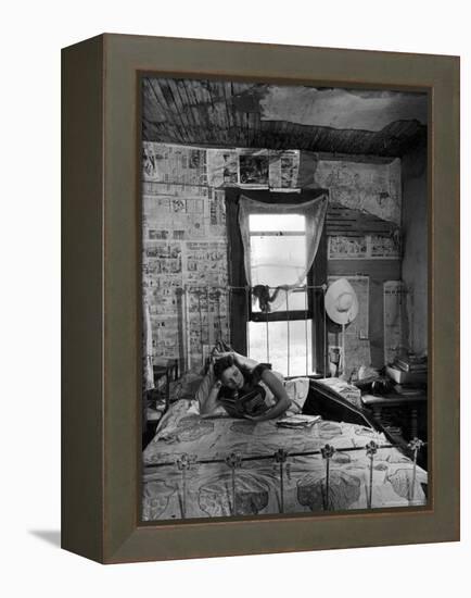 Farmer's Daughter Delphaline, Reading a Book as She Lies on Iron Bed in Her Bedroom-Alfred Eisenstaedt-Framed Premier Image Canvas