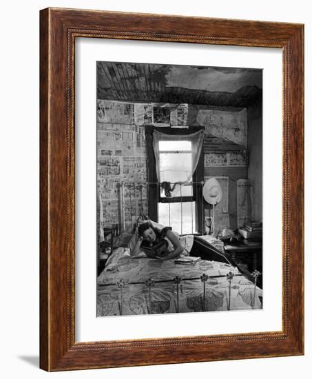 Farmer's Daughter Delphaline, Reading a Book as She Lies on Iron Bed in Her Bedroom-Alfred Eisenstaedt-Framed Photographic Print