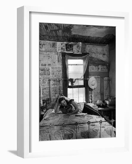 Farmer's Daughter Delphaline, Reading a Book as She Lies on Iron Bed in Her Bedroom-Alfred Eisenstaedt-Framed Photographic Print