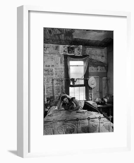 Farmer's Daughter Delphaline, Reading a Book as She Lies on Iron Bed in Her Bedroom-Alfred Eisenstaedt-Framed Photographic Print