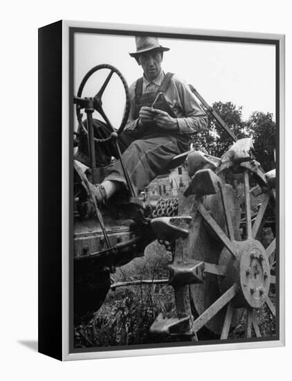 Farmer Sitting on Plow-null-Framed Premier Image Canvas