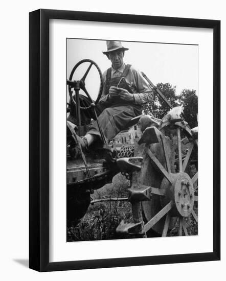 Farmer Sitting on Plow-null-Framed Photographic Print