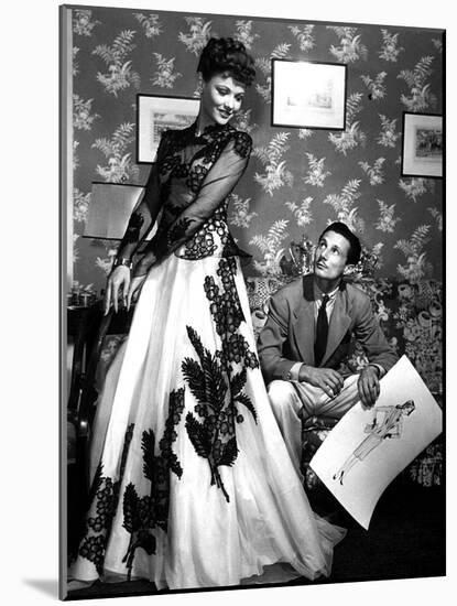 Fashion Designer Oleg Cassini Showing His Drawings to Gene Tierney to Show Her the Clothes in 1941-null-Mounted Photo