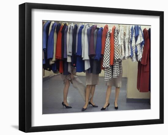 Fashion Models Behind a Suit Rack Trying on Clothes at Zelinka-Matlick, New York, New York, 1960-Walter Sanders-Framed Photographic Print