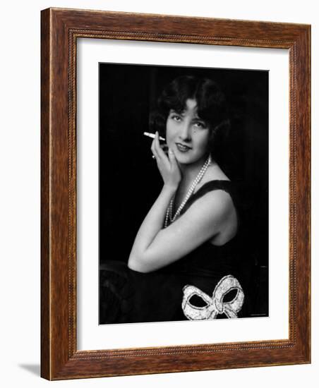 Fashionable Woman with Cigarette Holder in Hand Wearing Long Double Strand Pearl Necklace-null-Framed Photographic Print