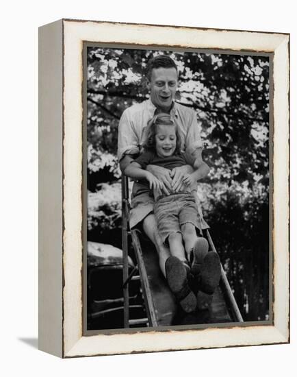 Father and Daughter Playing on Slide During Father's Day at Co-Op Nursery School Owned by Parents-Yale Joel-Framed Premier Image Canvas