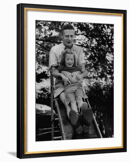 Father and Daughter Playing on Slide During Father's Day at Co-Op Nursery School Owned by Parents-Yale Joel-Framed Photographic Print