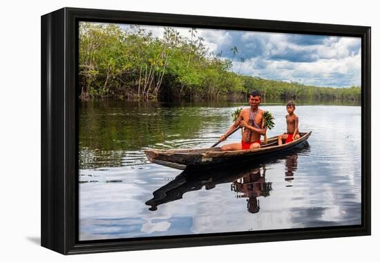 Father and son from the Yanomami tribe in a canoe, southern Venezuela-Michael Runkel-Framed Premier Image Canvas