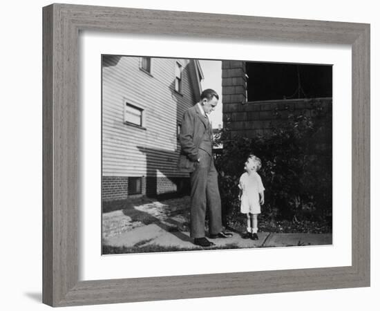 Father and Son Look at Each Other on Sidewalk, Ca. 1930.-Kirn Vintage Stock-Framed Photographic Print