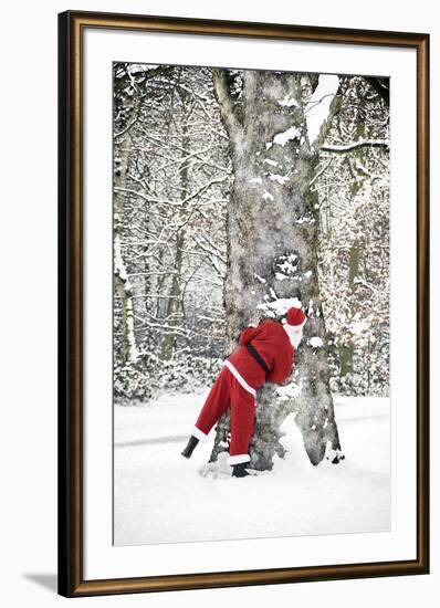 Father Christmas in Snow Behind Tree-null-Framed Photographic Print