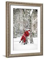 Father Christmas in Snow Behind Tree-null-Framed Photographic Print