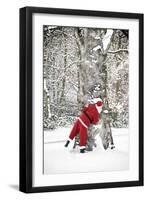 Father Christmas in Snow Behind Tree-null-Framed Photographic Print