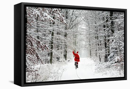 Father Christmas Riding Bicycle Through Beech-null-Framed Premier Image Canvas