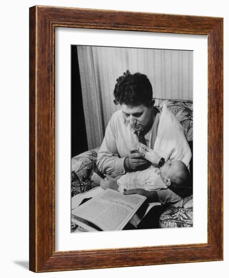 Father Feeding His Baby So That His Wife Can Go to the Movies-Alfred Eisenstaedt-Framed Photographic Print