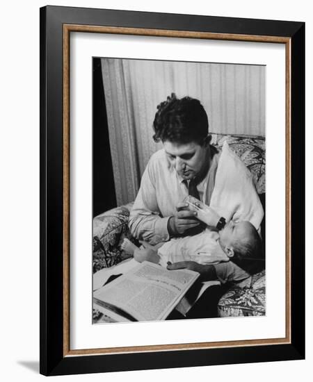 Father Feeding His Baby So That His Wife Can Go to the Movies-Alfred Eisenstaedt-Framed Photographic Print