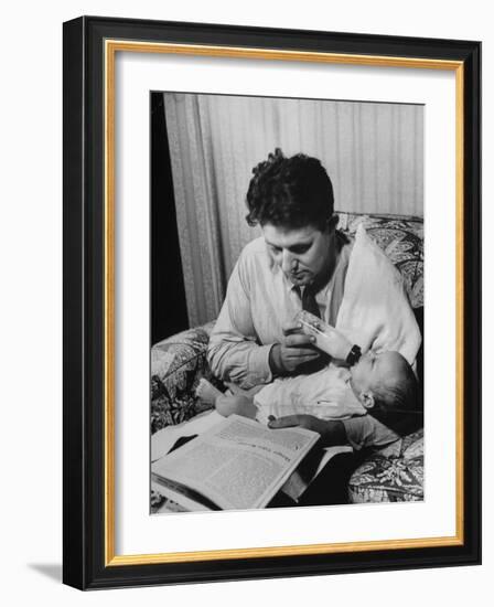 Father Feeding His Baby So That His Wife Can Go to the Movies-Alfred Eisenstaedt-Framed Photographic Print