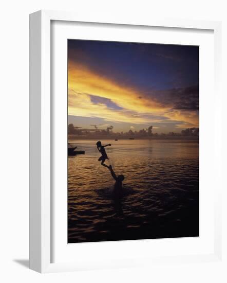 Father Playfully Throwing Son in Water-Barry Winiker-Framed Photographic Print