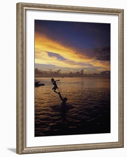 Father Playfully Throwing Son in Water-Barry Winiker-Framed Photographic Print