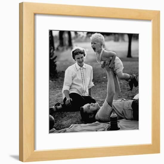 Father Playing with His Child During a Picnic-Allan Grant-Framed Photographic Print