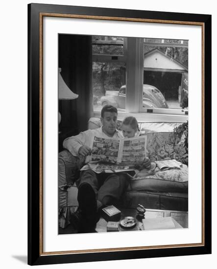 Father Sitting on Couch with Pigtailled Daughter Reading to Her the Sunday Comic Pages-Nina Leen-Framed Photographic Print