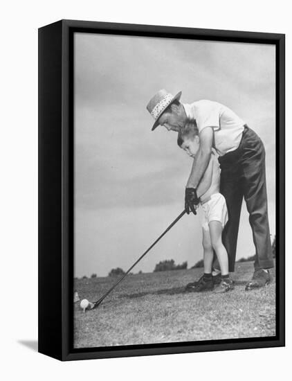 Father Teaching His Small Son How to Play Golf-null-Framed Premier Image Canvas