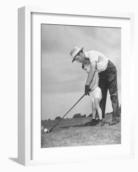 Father Teaching His Small Son How to Play Golf--Framed Photographic Print