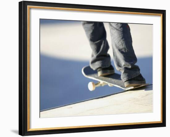 Feet on a Skateboard at the Edge of a Ramp--Framed Photographic Print