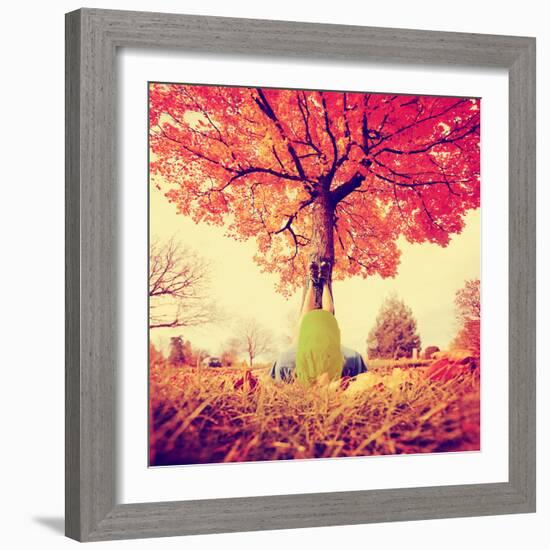 Feet Resting on a Tree Trunk during Fall When the Leaves are Turning Colors Toned with a Retro Vint-graphicphoto-Framed Photographic Print
