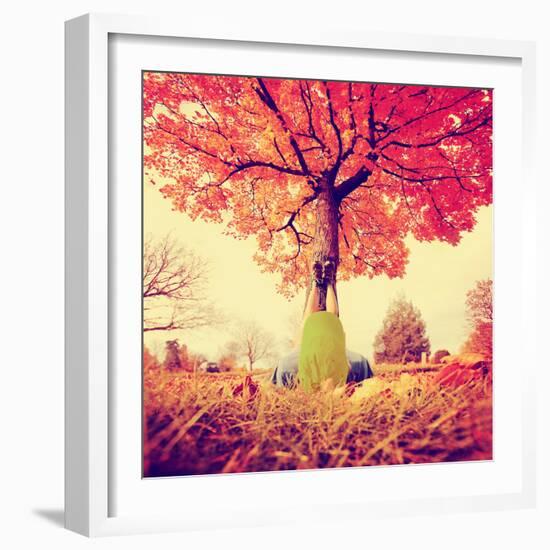 Feet Resting on a Tree Trunk during Fall When the Leaves are Turning Colors Toned with a Retro Vint-graphicphoto-Framed Photographic Print