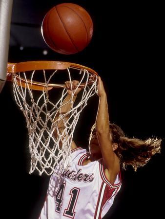 female basketball player dunking