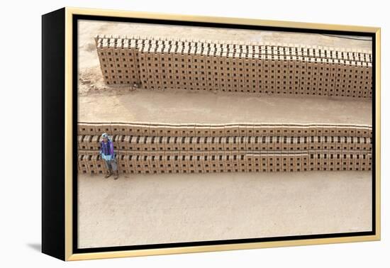 Female Brick Worker Standing Beside Hand Made Bricks Stacked to Dry before Baking, Rajasthan, India-Annie Owen-Framed Premier Image Canvas