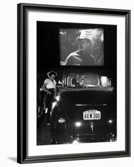 Female Car-Hop Taking Order from Couple in Convertible Car During Movie at Rancho Drive in Theater-Allan Grant-Framed Photographic Print