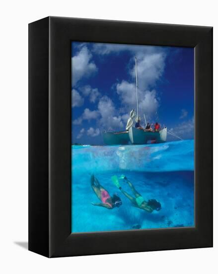 Female Divers Submerged Below Catamaran-Amos Nachoum-Framed Premier Image Canvas