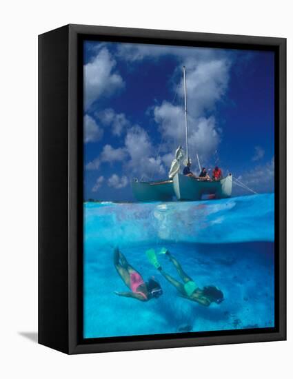 Female Divers Submerged Below Catamaran-Amos Nachoum-Framed Premier Image Canvas