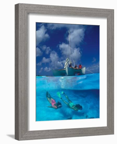 Female Divers Submerged Below Catamaran-Amos Nachoum-Framed Photographic Print