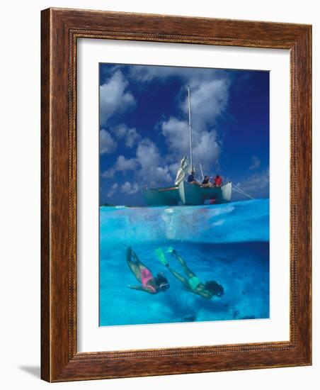 Female Divers Submerged Below Catamaran-Amos Nachoum-Framed Photographic Print