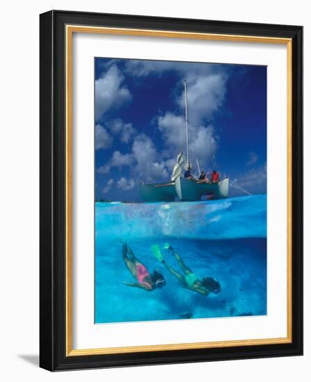 Female Divers Submerged Below Catamaran-Amos Nachoum-Framed Photographic Print