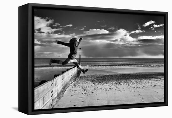 Female Figure Jumping on a Beach-Rory Garforth-Framed Premier Image Canvas