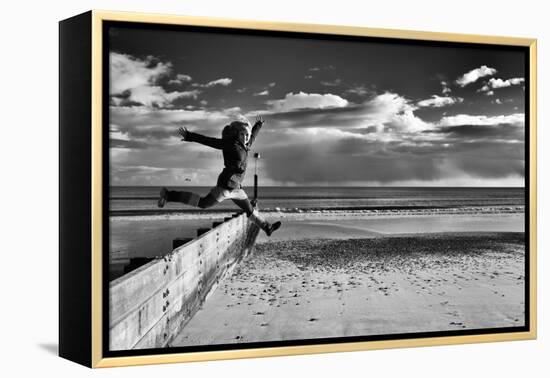 Female Figure Jumping on a Beach-Rory Garforth-Framed Premier Image Canvas